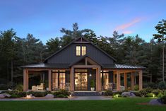 a house is lit up at night with lights on the front porch and covered patio