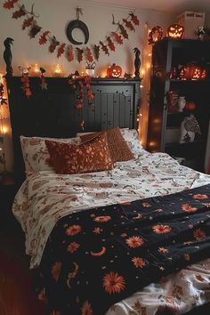 a bedroom decorated for halloween with pumpkins and decorations on the wall above the bed