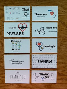 thank you cards with medical symbols on them are arranged on a wooden table in front of a computer keyboard