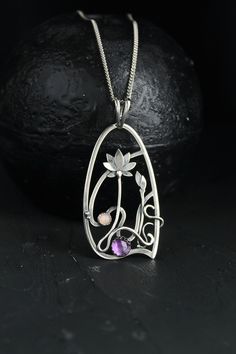 The size H 4 cm x W 3 cm (1 3/4 x 1 inch). Weight - 6g. You can buy it with the chain or without. The most delicate flower of the lotus can make someone very happy. I made this botanical jewelry of sterling silver, amethyst, and peach moonstone. This is a true work of art. It will emphasize your exquisite taste and status, and will also bring a lot of compliments. Lotus flower earrings https://www.etsy.com/listing/676137548/lotus-flower-earrings-sterling-silver?ref=shop_home_active_2&frs=1 O Handmade Art Nouveau Pendant Necklace, Purple Amulet Jewelry As Gift, Purple Amulet Jewelry As A Gift, Purple Amulet Style Jewelry Gift, Handmade Art Nouveau Necklace For Gift, Handmade Art Nouveau Necklace Gift, Handmade Art Nouveau Jewelry Gift, Handmade Art Nouveau Jewelry, Artistic Flower Pendant Jewelry Gift