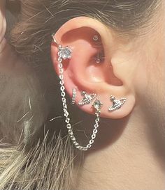 a woman with ear piercings and chains