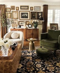 a living room filled with furniture and pictures on the wall