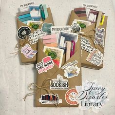 an open book with many different stickers on it and tied up in brown paper