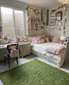 a bedroom decorated in pink and green with lots of decorations on the walls, bedding and rugs