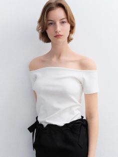 This is ARCHAIC’s clean-cut off-shoulder t-shirt exudes a glamorous yet sophisticated vibe, allowing you to effortlessly pull off various looks. Its basic yet unique style makes it a perfect match for any outfit.- Ideal for daily wear- Can be paired with different bottoms to create various looks- The off-shoulder design adds a stylish touch to the look Chic Fitted Top T-shirt For Night Out, Chic Stretch T-shirt For Night Out, Modern Off-shoulder Tops For Night Out, Elegant Stretch Knit Top For Day Out, Elegant Stretch Off-shoulder Knit Top, Elegant Summer T-shirt, Elegant Off-shoulder Stretch Knit Top, Chic Knit Top For Day Out, Chic Stretch White Short Sleeve Top