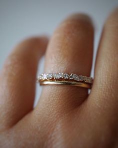 a woman's hand with a wedding ring on her finger, showing the diamond band