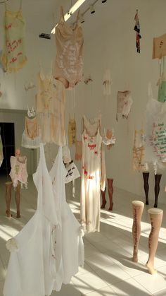 there are many dresses hanging from the ceiling