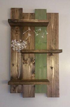 a wooden shelf with some dandelions on it