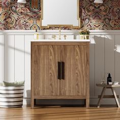 a bathroom vanity with a mirror above it next to a wooden stool and wallpaper