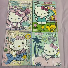 three hello kitty coloring books on a bed