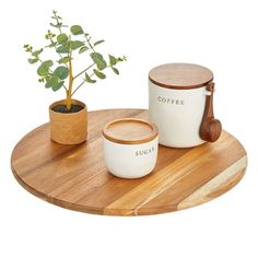 two coffee mugs and a potted plant on a wooden tray