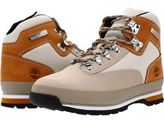 a pair of brown and white hiking boots