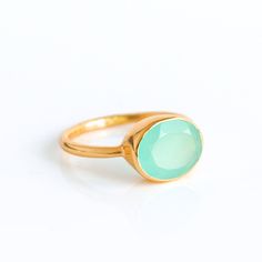 "You'll fall in love with the pastel seafoam green coloring of this Aqua Chalcedony ring. This is a perfectly sized oval to compliment any collection. Popular as a birthday gift for those March babes and aquamarine lovers alike. This is a light, opaque blue-green gemstone with no flaws. This stone is beautifully faceted and bezel set in a 925 sterling silver band or plated with 18k vermeil gold. Gemstone is approximately 8 x 12mm. Band has 925 stamp on inside. Please note that each ring is handm Oval Aquamarine Birthstone Ring As Gift, Oval Aquamarine Birthstone Ring For Gift, Green Aquamarine Rings As A Gift, Green Aquamarine Rings For Gifts, Green Aquamarine Ring For Gift, Emerald Oval Cabochon Ring Gift, May Birthstone Rings In Oval Cabochon Shape, May Birthstone Oval Cabochon Rings For Gift, Green Gemstone Ring For Birthday