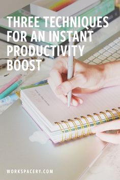 a person writing on a notebook with the words three techniques for an instant productivity booster