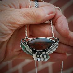 This incredible fancy jasper stone is set in sterling silver, accented in flowers and leaves. The overall effect is feminine and elegant. Fancy Jasper, Larimar Earrings, Blue Onyx, Soldering Jewelry, My Community, Moonstone Necklace, Jasper Stone, Rust Color, Jewelry Inspo