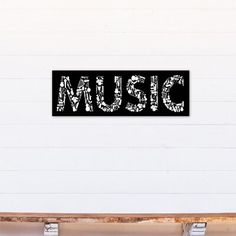 there is a sign that says music on the wall