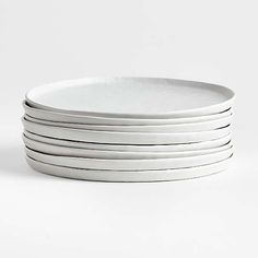 six white plates stacked on top of each other