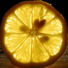 an orange cut in half sitting on top of a wooden table