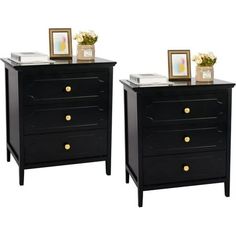 two black nightstands side by side with pictures on top and flowers in the middle