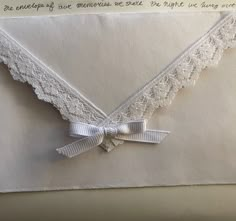 an envelope decorated with lace and ribbon