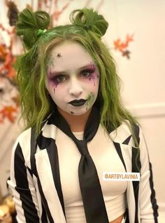 a woman with green hair and makeup is dressed up as beetlegy girl from beetlejuice