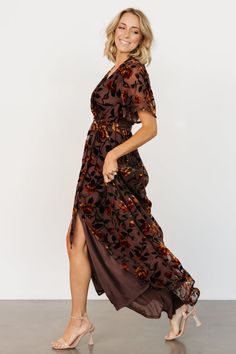 Say hello to our Uma Velvet Maxi Dress! This gorgeous dress features clove velvet material with a unique burnout mesh floral print. Belted Brown Party Dress, Brown Short Sleeve Midi Dress For Party, Brown Short Sleeve Maxi Dress For Party, Short Sleeve Brown Dress For Evening, Brown Short Sleeve Dress For Evening, Brown Short Sleeve Party Dress, Brown Short Sleeve Dress With Floral Print, Brown Short Sleeve Dress With Tie Waist, Baltic Born