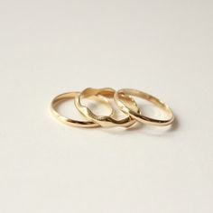 Named after the Ionian Sea in the Mediterranean, the Ionian Ring Stack features our best selling gold band trio. Play with subtle waves of negative space with our Low Tide band set between two of our 2mm bands. This ring stack is the perfect symbol to bring calm to your day to day. Perfect if you’re looking for an alternative wedding ring, or a vow ring for the non-traditional bride. Normally $950 when bought individually, with this set you get all three at a discount. This style is made to orde Minimalist Yellow Gold Rings With Decorative Band, Minimalist Yellow Gold Ring With Decorative Band, Elegant Hammered Stackable Rings, Minimalist 14k Gold Ring With Decorative Band, Stackable 14k Gold Midi Rings With Thick Band, Minimalist Yellow Gold Jewelry With Decorative Band, Minimalist 14k Gold Band With Decorative Details, Minimalist Yellow Gold Toe Ring Bands, Minimalist Hammered Round Band Ring