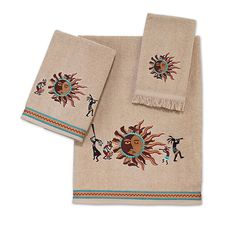 two towels with embroidered sun design on the front and back, one in beige color