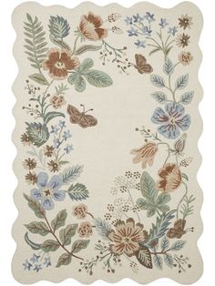 a white rug with flowers and leaves on it