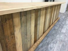 a wooden counter sitting on top of a hard wood floor