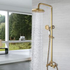 a shower head with thermostaer and handset in front of a window