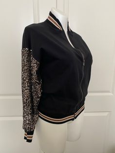 There is nothing like the feel of this Italian Jersey paired with the soft stretchy sparkle sequined sleeves that announce, I’m here! This sassy little jacket tops nearly everything and has all the attitude you need to take you back out into the real world. One size fits up to a 16 Made of 95% Cotton 5% Elastane Made in Italy Waistband hits at the high waistline Collar and waistband made of soft stretched ribbed jersey too Sleeves made of stretch sequins fabric allowing for fit Trendy Spring Outerwear With Contrast Sequin, Stretch Glitter Tops For Fall, Fitted Contrast Sequin Outerwear For Fall, Spring Outerwear With Glitter For Night Out, Fall Fitted Outerwear With Contrast Sequin, Winter Tops With Contrast Sequin, Winter Contrast Sequin Tops, Black Outerwear With Contrast Sequin For Winter, Winter Black Outerwear With Contrast Sequin