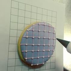 a cookie is being decorated on the side of a wall next to a crayon marker