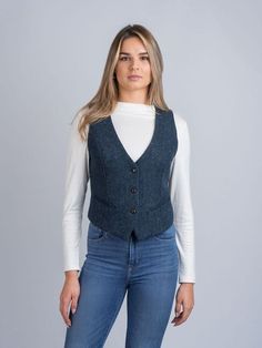 A must for Ladies who love trends, shape and function in their clothing. This Irish designed  piece is trendy yet functional. This  garment is shaped to combine traditional tailoring with a contemporary edge. This tweed waistcoat is a visually stunning  key piece  that is made for any occasion. The herringbone blue tweed has flecks of color that give it a unique oceanic feel. Wear with denim for a more  casual look or with a skirt for a more formal occasion.   The Celtic Tweed ladies collection of tweed waistcoats and vests are our interpretation on timeless Irish design. Our tweed waistcoats offer our wearers a fluid and tailored silhouette that is perfect for creating a classic yet contemporary look. Our ladies waistcoats are unique handmade from tweeds and linen resulting in flattering Tweed Vest For Workwear In Fall, Fitted Wool Vest For Fall, Winter Tweed Vest For Work, Winter Workwear Tweed Vest, Casual Tweed Vest For Winter, Tailored Tweed Vest For Fall, Fitted Tweed Vest For Fall, Fitted Tweed Vest For Work, Fitted Casual Tweed Outerwear