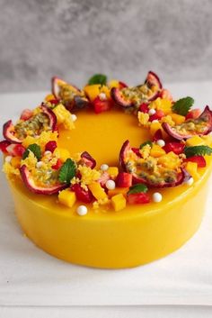 a yellow cake with fruit on top