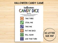 the halloween candy dice game is shown on a wooden table