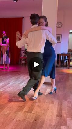 two people are dancing on the dance floor