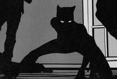 a black and white image of a batman standing in front of a window with his shadow on the floor