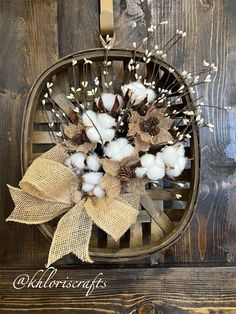 a basket filled with cotton and pine cones