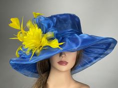 Blue Mini Hats For Summer Races, Blue Top Hat For Summer Wedding, Blue Wedding Hat For Spring, Blue Brimmed Top Hat For Royal Ascot, Blue Spring Wedding Hat, Blue Top Hat For Church In Spring, Brimmed Blue Top Hat For Royal Ascot, Blue Top Hat For Spring Church Events, Blue Mini Hat For Formal Spring Events