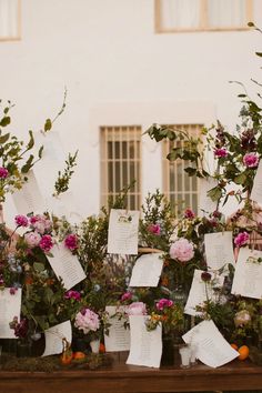 flowers and notes are on display in front of a building