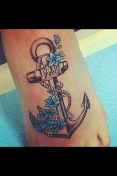 an anchor with blue flowers on the foot