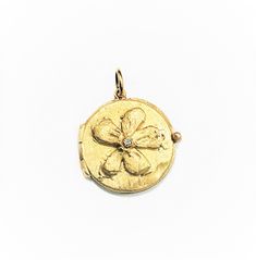 "This beautiful 14 Karat yellow gold \"Flower Locket\" pendant is embellished with a diamond of 0.02 ct. on the center and all handmade by Carolyn. Diamonds approx. 0.02 ct. weight Total weight of gold is 5 grams. Bale would accommodate approx. 1.5 - 2mm chain. Can be ordered in rose or white gold. 14K Yellow Gold 16\" long chain can be purchased separately for $80." Diamond Pendant With Flower Charm, Yellow Gold Diamond Flower Jewelry, Yellow Gold Pendant Jewelry With Flower Charm, Yellow Gold Diamond Flower Pendant Jewelry, Gold Medallion With Single Cut Diamonds, 14k Yellow Gold Jewelry With Flower Charm, Gold Flower-shaped Jewelry With Single Cut Diamonds, Gold Flower Jewelry With Single Cut Diamonds, Hallmarked Yellow Gold Flower Jewelry