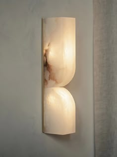 a wall light that is mounted to the side of a wall with two lights on it