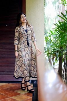 a woman standing next to a wooden door