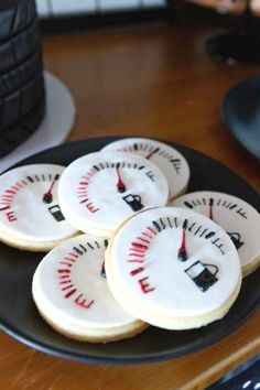 some cookies are on a black plate with white frosting