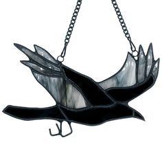 a stained glass bird hanging from a chain