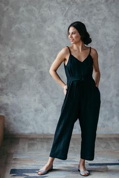 This timeless black linen jumpsuit will make you look effortless. Wide-fitting and made from comfortable, breathable soft washed linen fabric, this black jumpsuit is detailed with a tie belt at the waist to add shape (if you want to). These summer overalls are perfect for a busy day in the city and a quiet coffee date.***The Prancing Hare is the sister brand of Bunny Street, which was launched by Irene Sheyko in 2013. Drawing inspiration from there, The Prancing Hare boasts earthy, neutral aesth Fitted Linen Jumpsuits And Rompers For Spring, Spring Fitted Linen Jumpsuits And Rompers, Black Linen Jumpsuits And Rompers For Summer, Fitted Linen Jumpsuits And Rompers For Loungewear, Linen Dressing Gown, Jumpsuit Linen, Summer Overalls, Oversized Jumpsuit, Linen Overalls