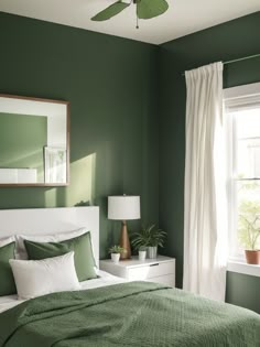 a bedroom with green walls and white bedding