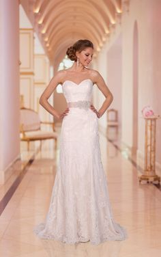 a woman in a white wedding dress standing on a tile floor